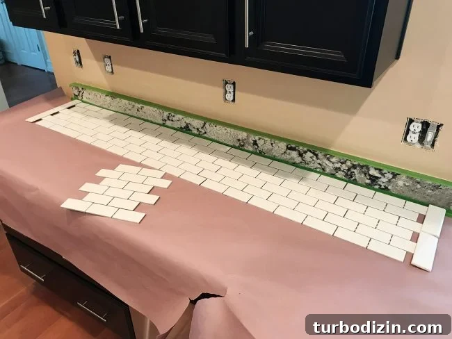 Install a Subway Tile Kitchen Backsplash for $200 DIY Guide 7 white subway tile sheets laid out on counter to finalize placement