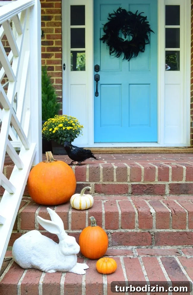3 Quick Front Porch Updates to Boost Curb Appeal 14 Halloween Porch Pumpkins Crow Feather Wreath