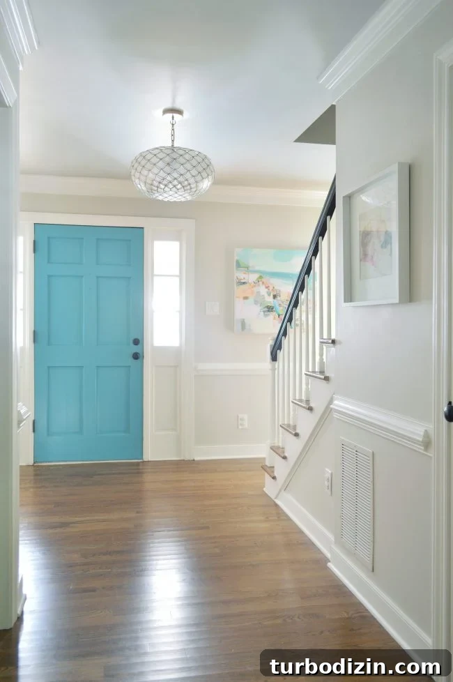Foyer Refresh: New Lighting and Furniture Ideas to Transform Your Entryway 11 neutral foyer edgecomb gray with blue front door