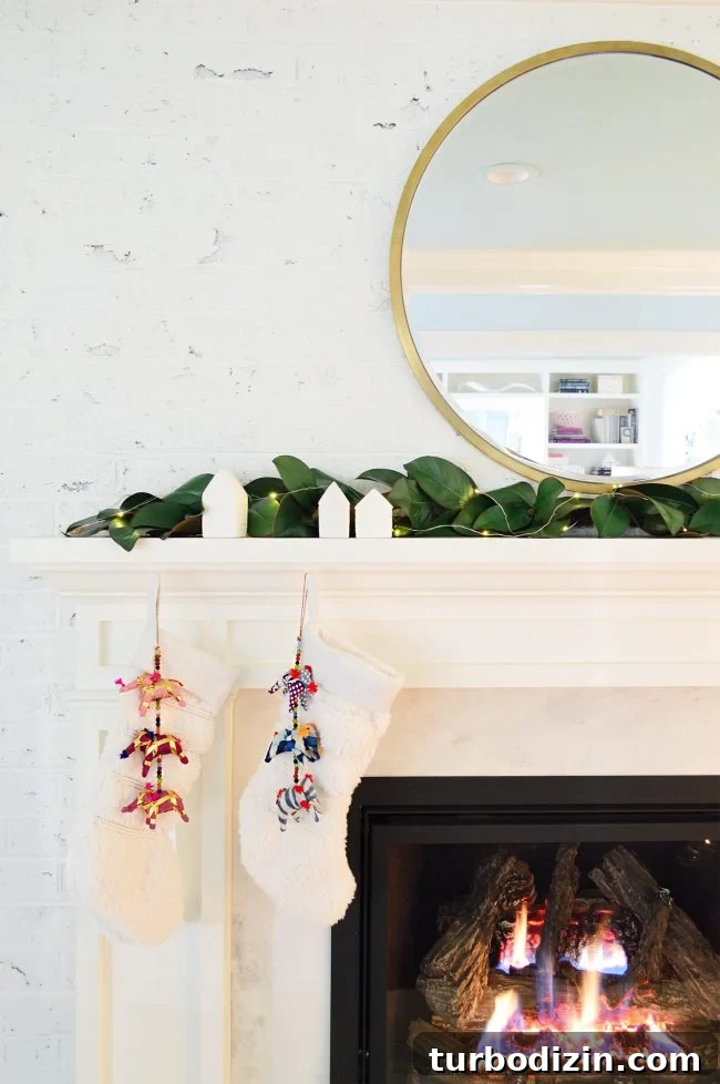Holiday Home Tour: See Our Christmas Decorating Ideas 4 Mantel with garland and houses