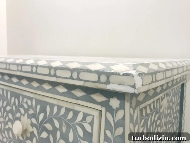 Repairing Cracked or Broken Inlay Furniture: Step-by-Step Guide 6 spackle fill to repair inlay tile that is missing or broken