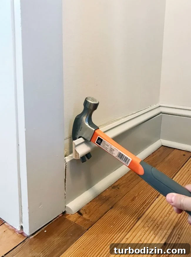 Build Custom Pantry Shelves: Step-by-Step Guide for Any Kitchen 6 hammer prying off baseboard molding in pantry
