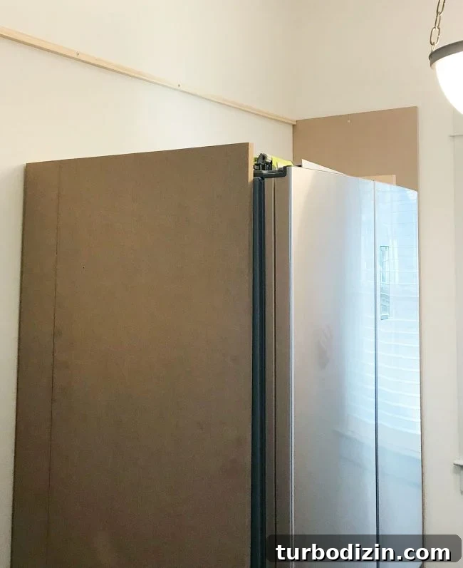 Build Custom Pantry Shelves: Step-by-Step Guide for Any Kitchen 7 large MDF pieces added vertically against fridge in pantry