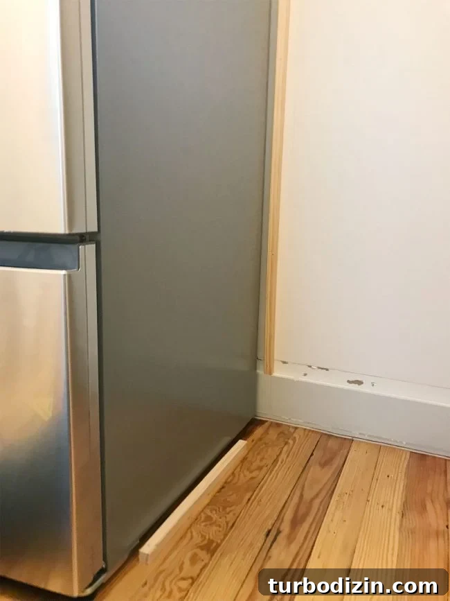 Build Custom Pantry Shelves: Step-by-Step Guide for Any Kitchen 8 thing pieces of wood installed near fridge on wall and floor