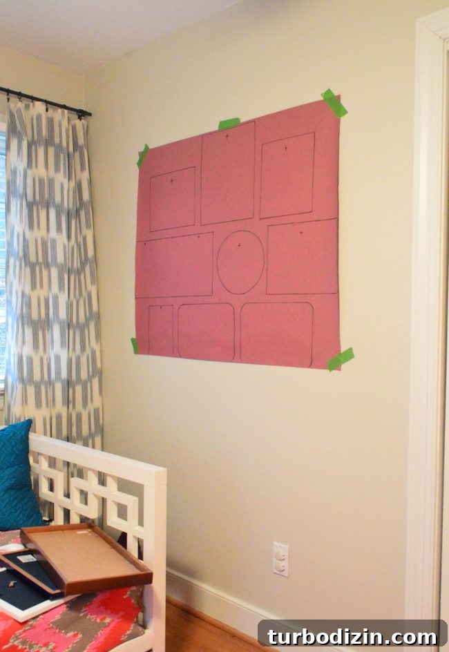 red rosin paper taped to wall with frame outlines drawn for gallery