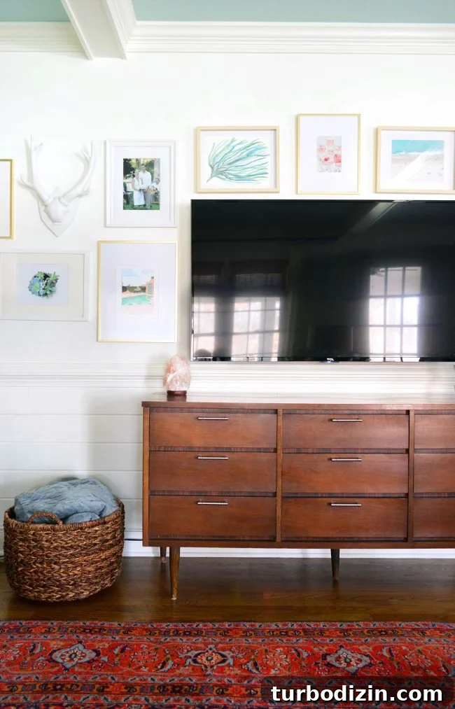 wood tv console with mounted tv and picture frame gallery