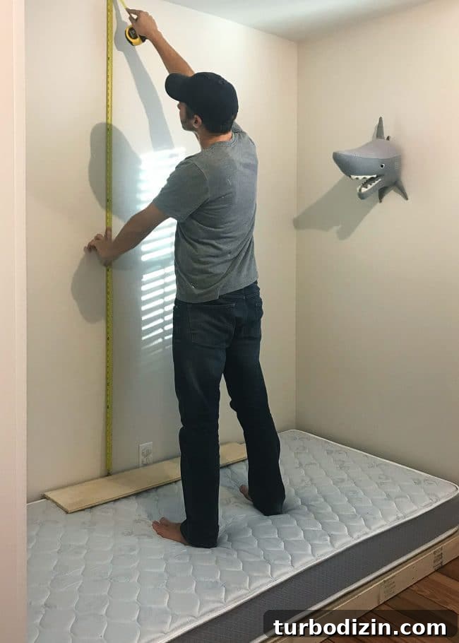 DIY Guide: Building Custom Built-In Bunk Beds for Your Home 10 John measuring height and placement of top bunk