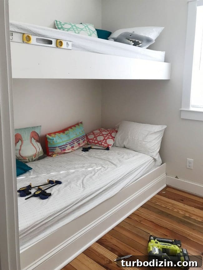 DIY Guide: Building Custom Built-In Bunk Beds for Your Home 15 white trim pieces added to the face of bunk bed platforms