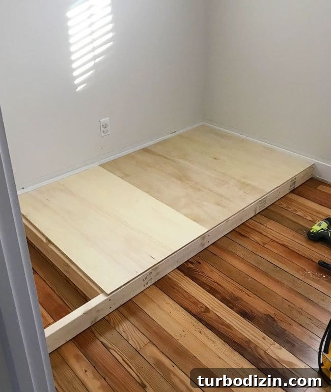 DIY Guide: Building Custom Built-In Bunk Beds for Your Home 8 adding plywood to create base of bottom bunk bed