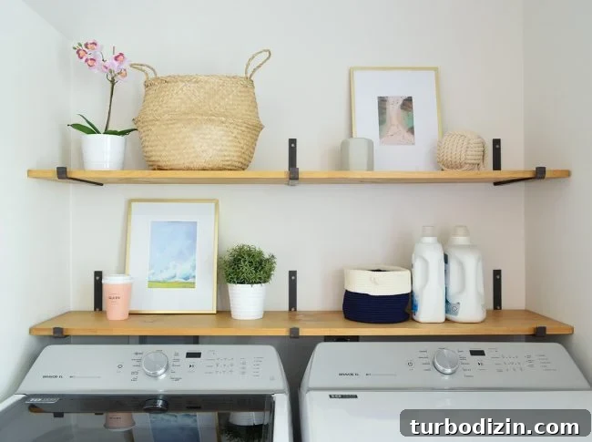 Conceal a Water Heater Using an IKEA Cabinet: Step-by-Step Guide 9 open shelves above top loading washing with dark iron brackets and wood shelves