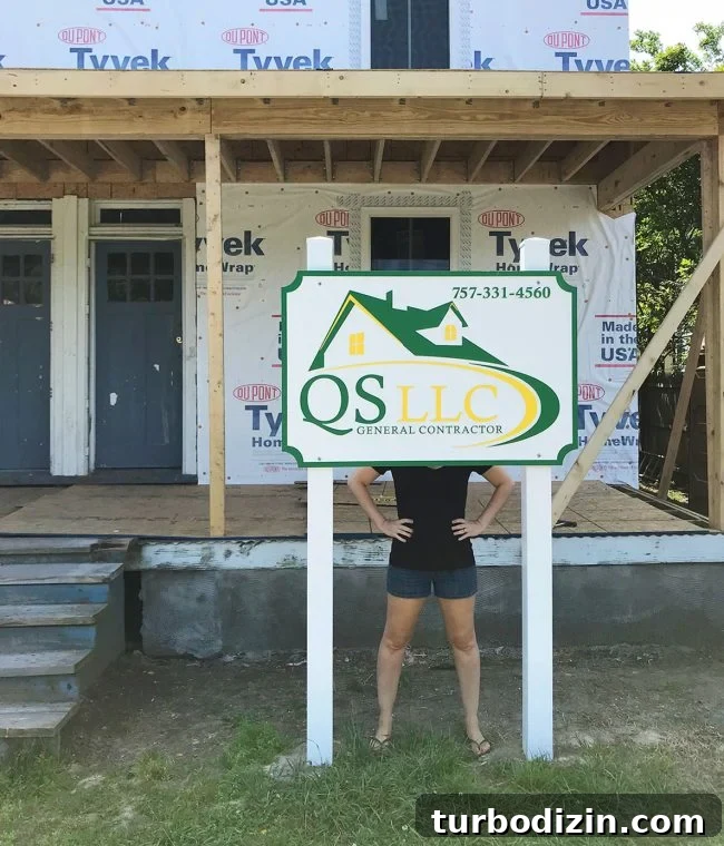 Duplex Renovation Complete: Fast Restoration of a Historic Home 22 Sean's company sign with Sherry for scale