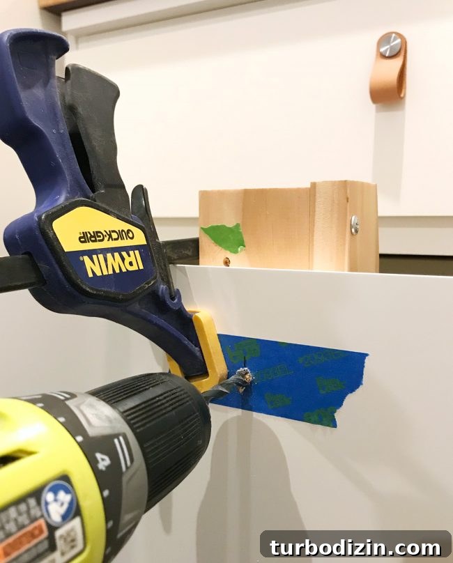 Convert an IKEA Malm into a Built-In Dresser: Step-by-Step Guide 13 Drilling hole in drawer of Ikea Dresser to add hardware