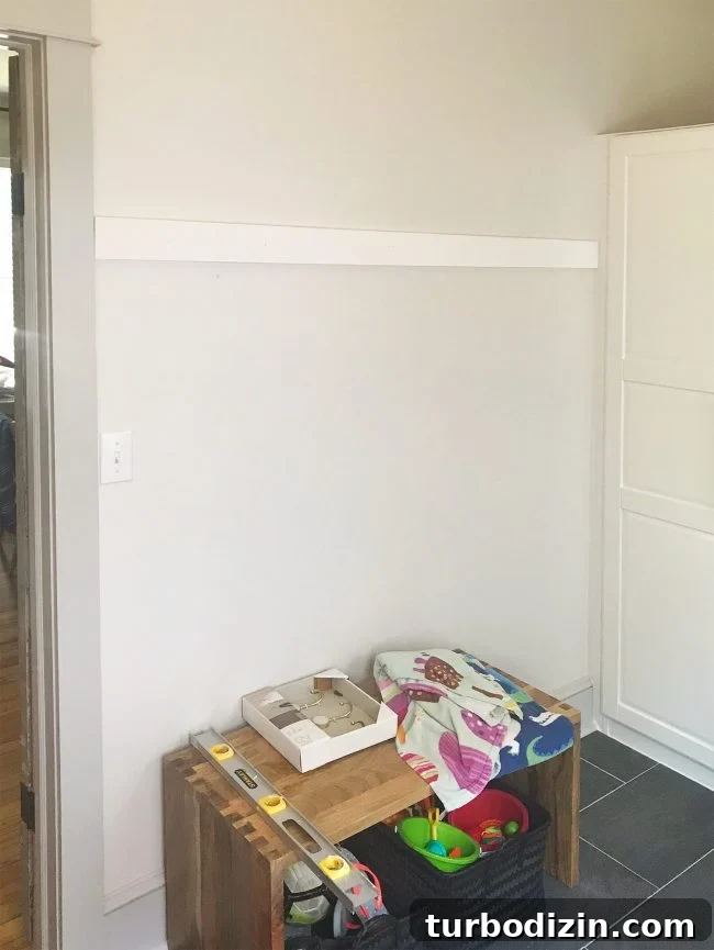 DIY Long Hook Rail for Mudroom: Step-by-Step Build & Install 5 white board hung on wall in mudroom