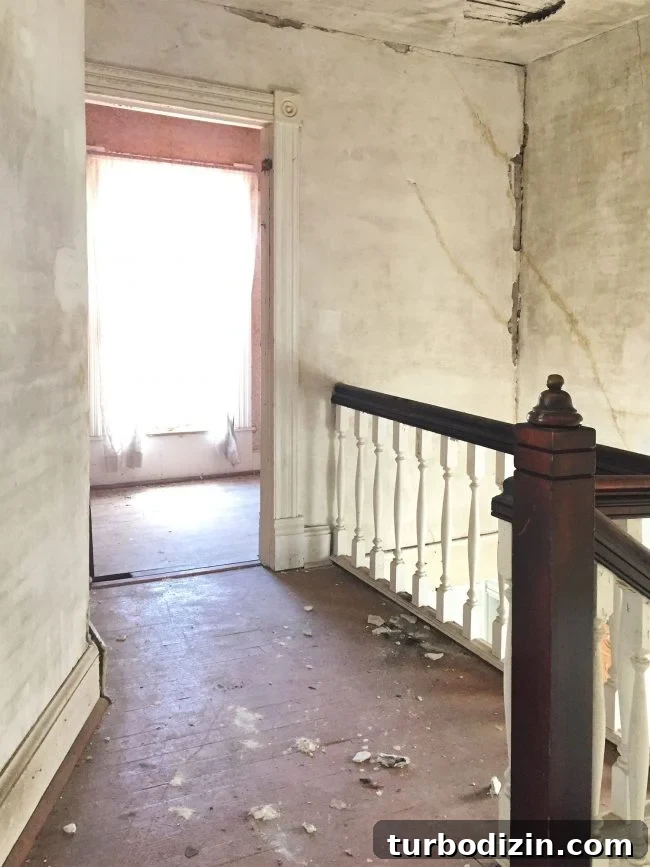 beach house before upstairs landing crumbling drywall painted floor