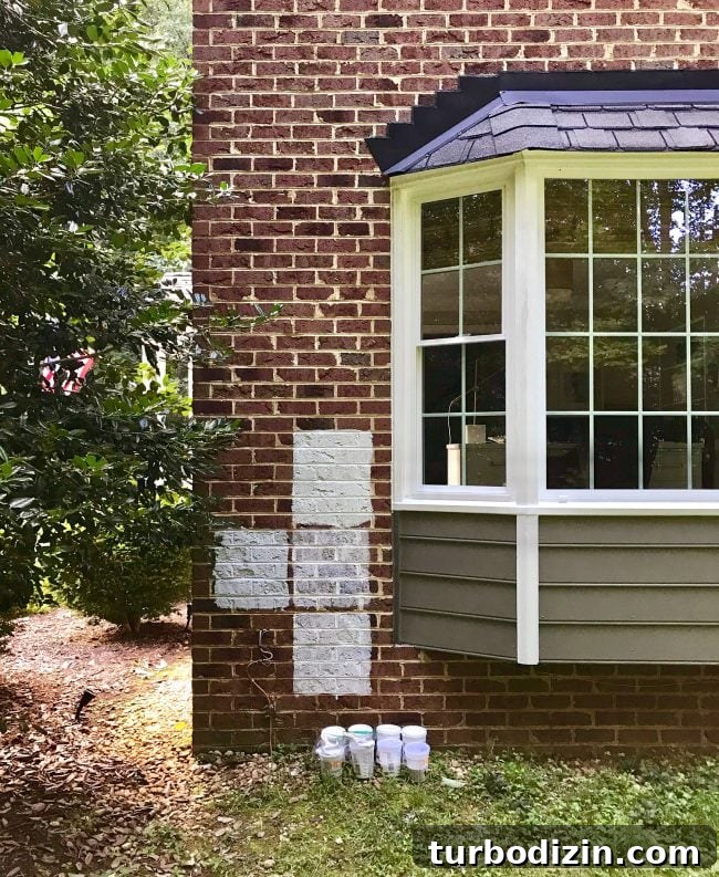 sample sections of white paint on brick house