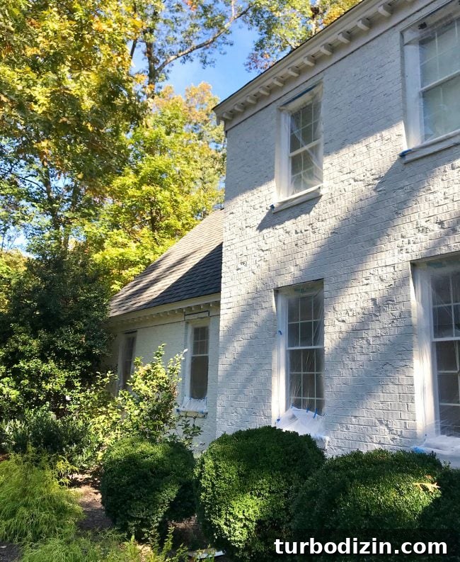 after photo of brick house painted sherwin williams moderne white