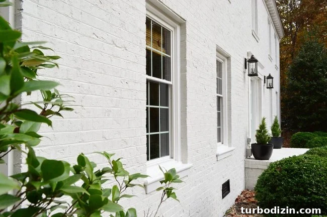 Close Up Photo Of White Painted Brick Home From Side