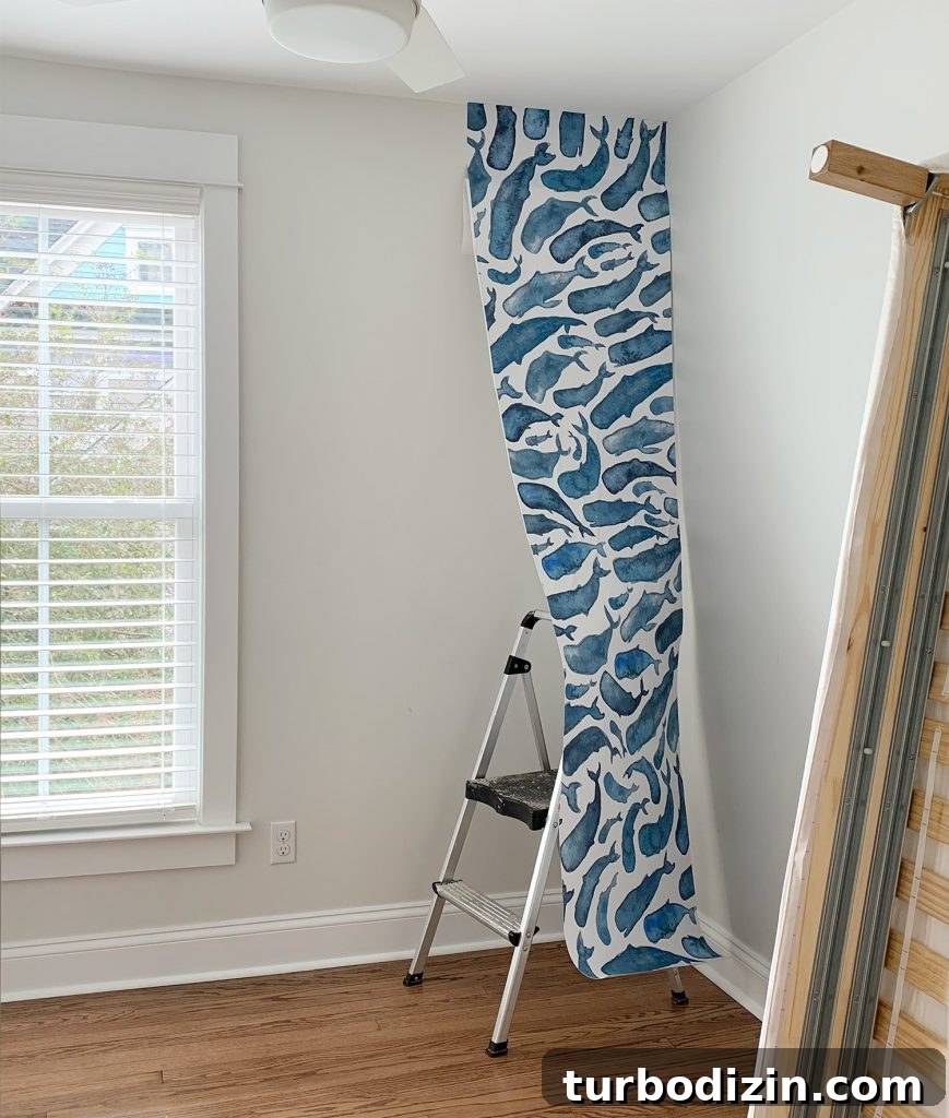 One Panel Of Whale Removable Wallpaper Partially Hung In Room