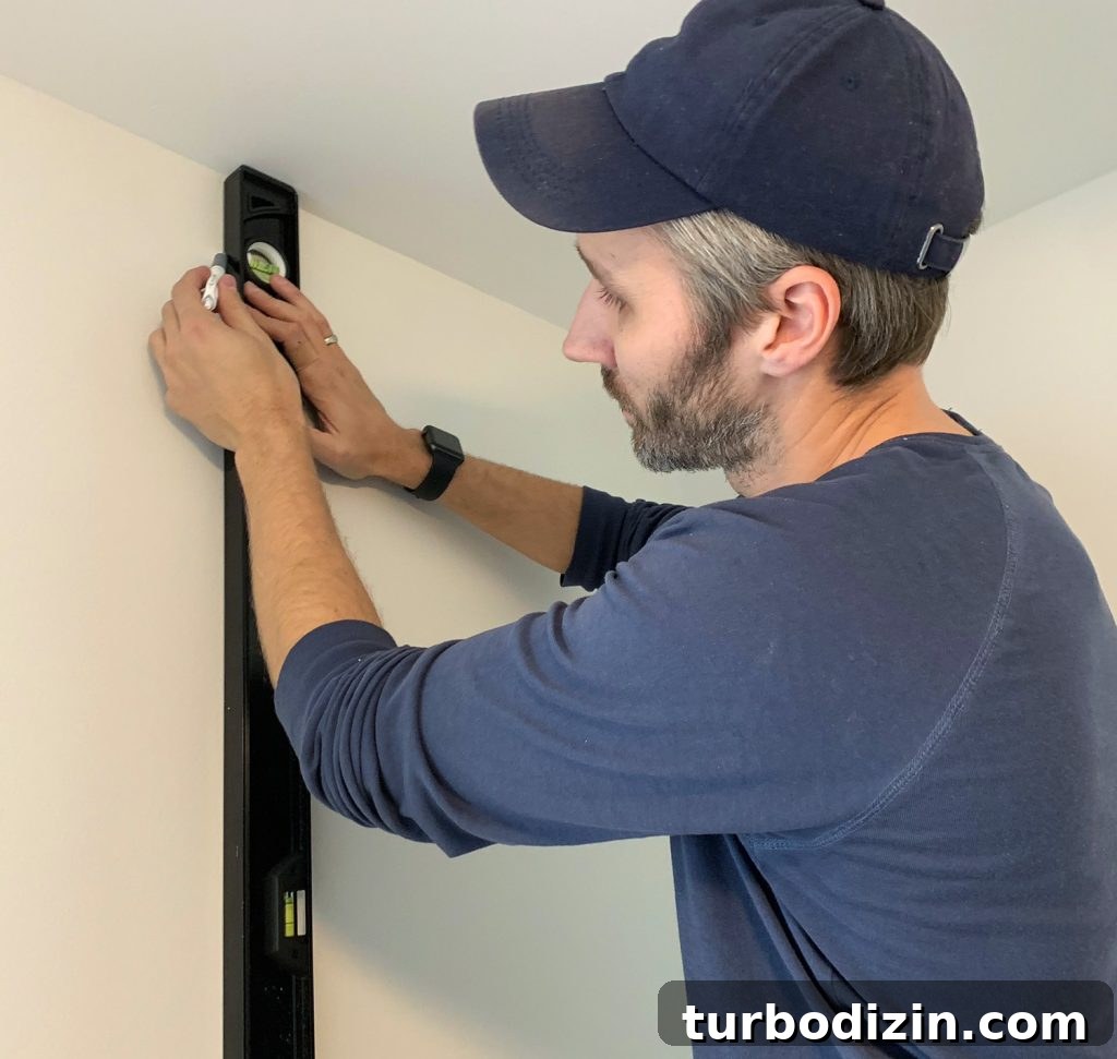 Drawing Vertical Level Line Before Hanging First Panel of Wallpaper
