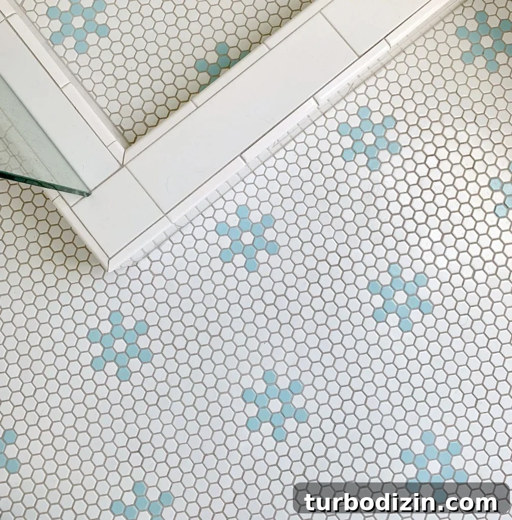 Hex tile bathroom floor with aqua blue flower shapes