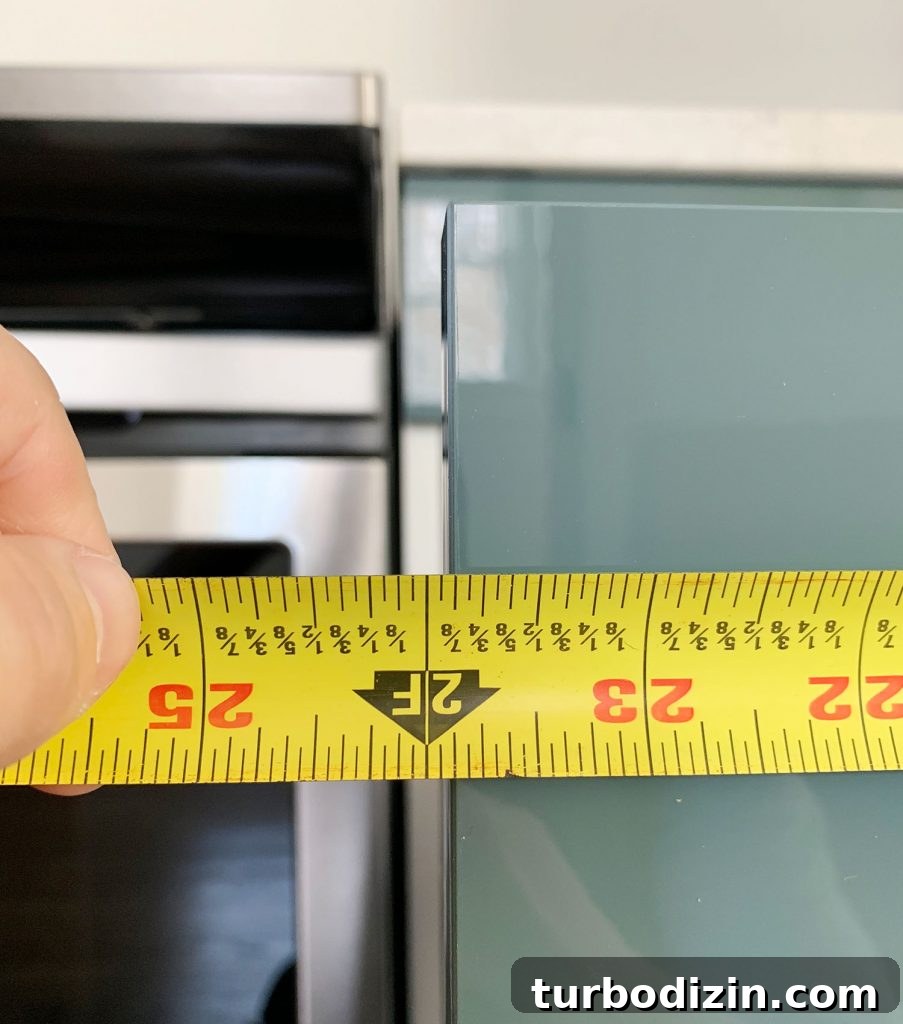 Measured Length Of Cabinet Drawer Front Using Tape Measure