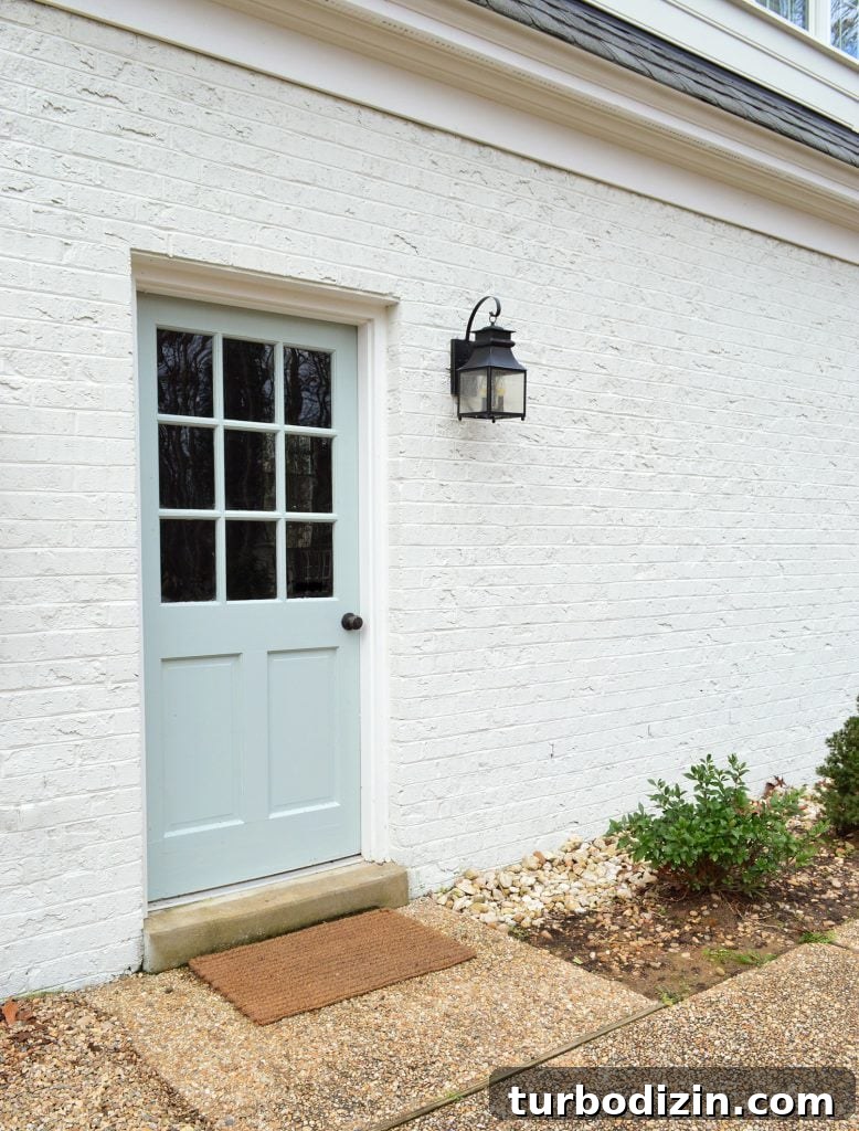 Front Door Paint Guide: Top Color Picks and Pro Tips for Painting a Door 6 Back Door Painted Tranquility In High Gloss Against White Brick Garage