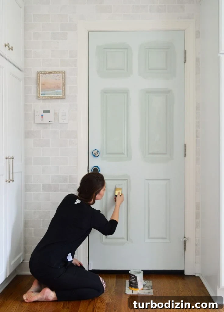 Front Door Paint Guide: Top Color Picks and Pro Tips for Painting a Door 8 Sherry Applying High Gloss Paint To Kitchen Door With Short Angled Brush
