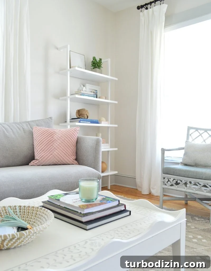 Bright, Airy Living Room Ideas That Stay Comfortable and Practical 10 close up of scalloped white coffee table showing inlay stenciled pattern on top
