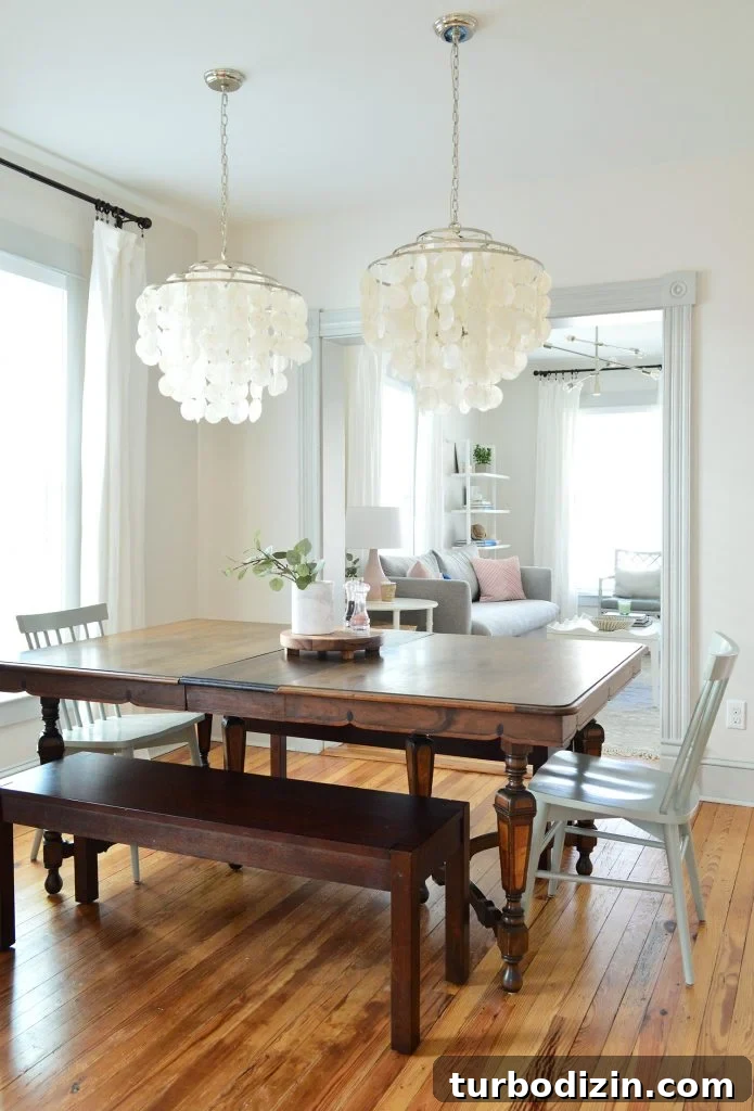 Bright, Airy Living Room Ideas That Stay Comfortable and Practical 16 vintage dining table with two capiz chandeliers over top