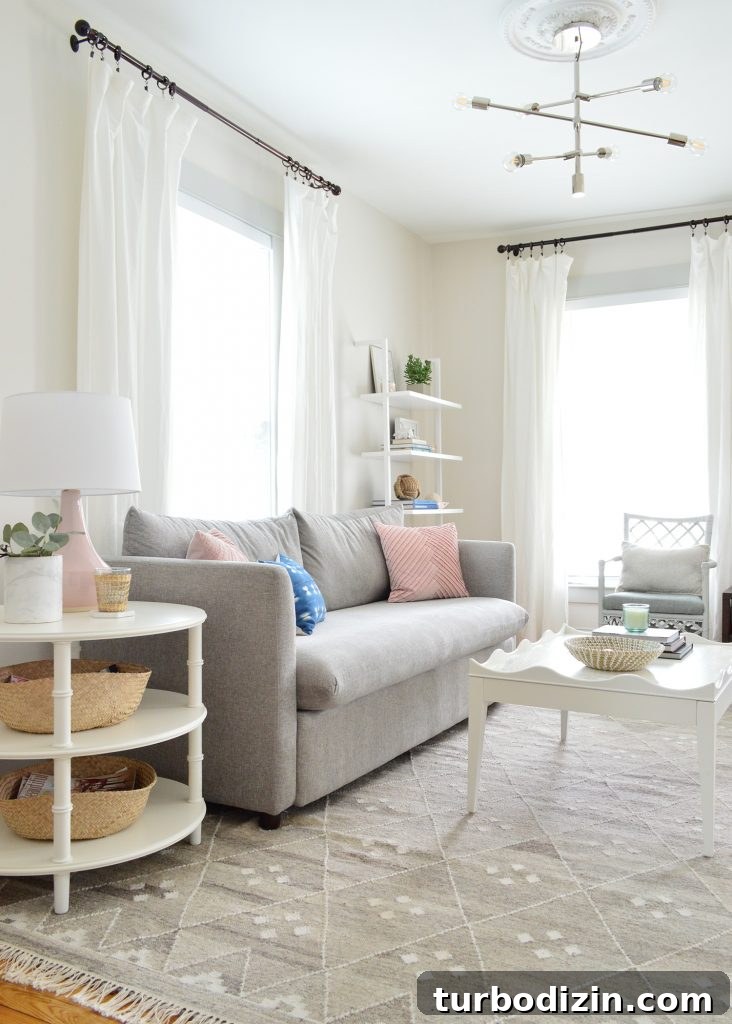 Bright, Airy Living Room Ideas That Stay Comfortable and Practical 6 bright neutral living room gray sofa with round side table and scalloped coffee table