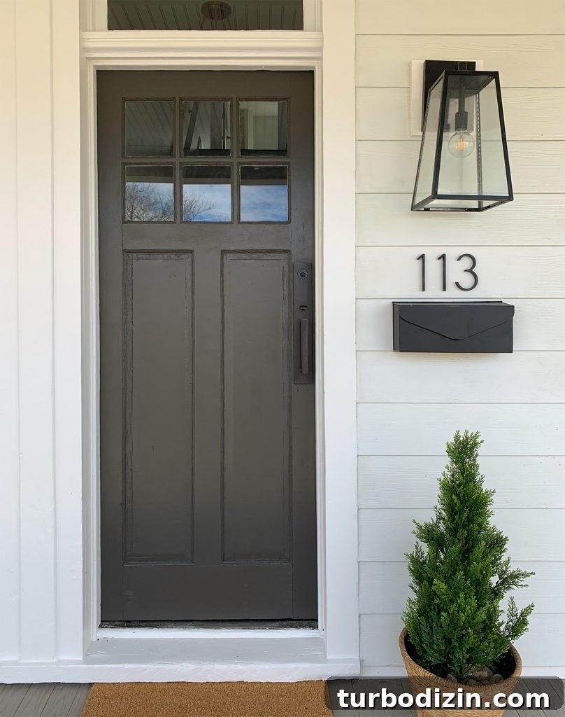 Duplex Front Porch Makeover: Stylish Curb Appeal Ideas 15 One Side Of Duplex Front Porch With Dark Door And Hardware