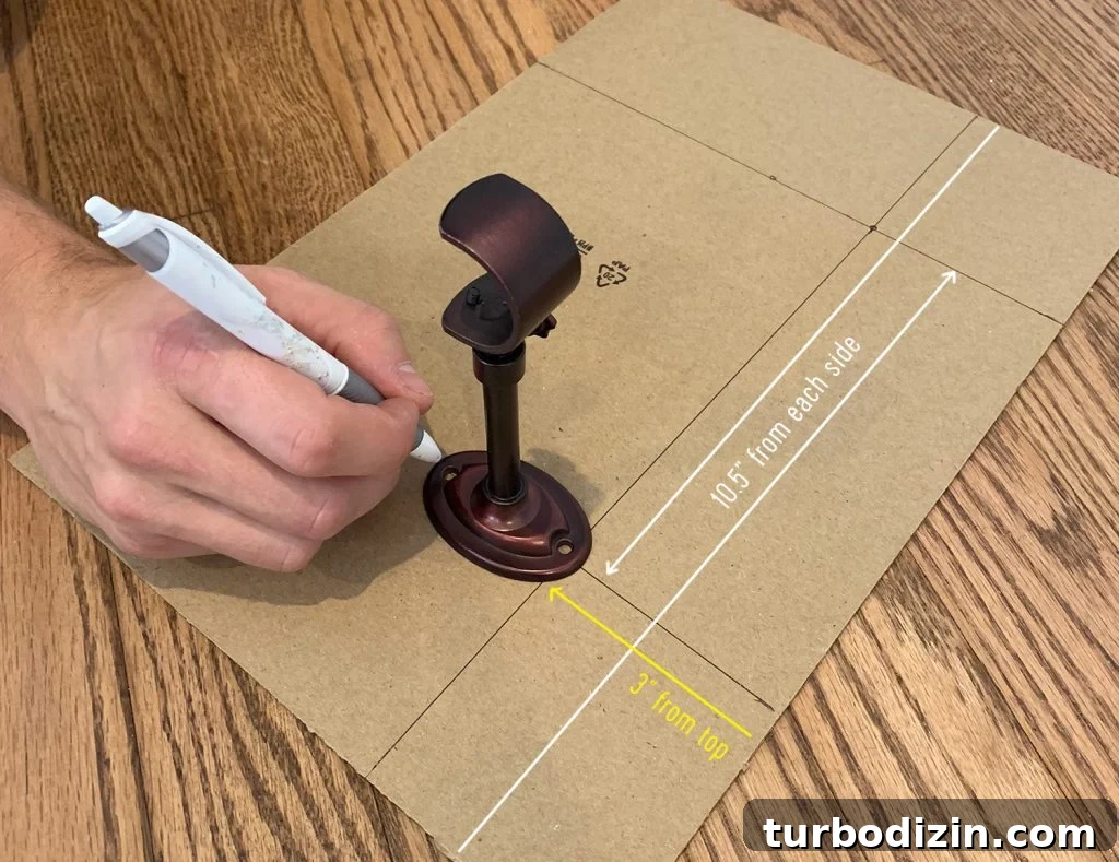 Marking lines on cardboard to make a curtain rod hanging template