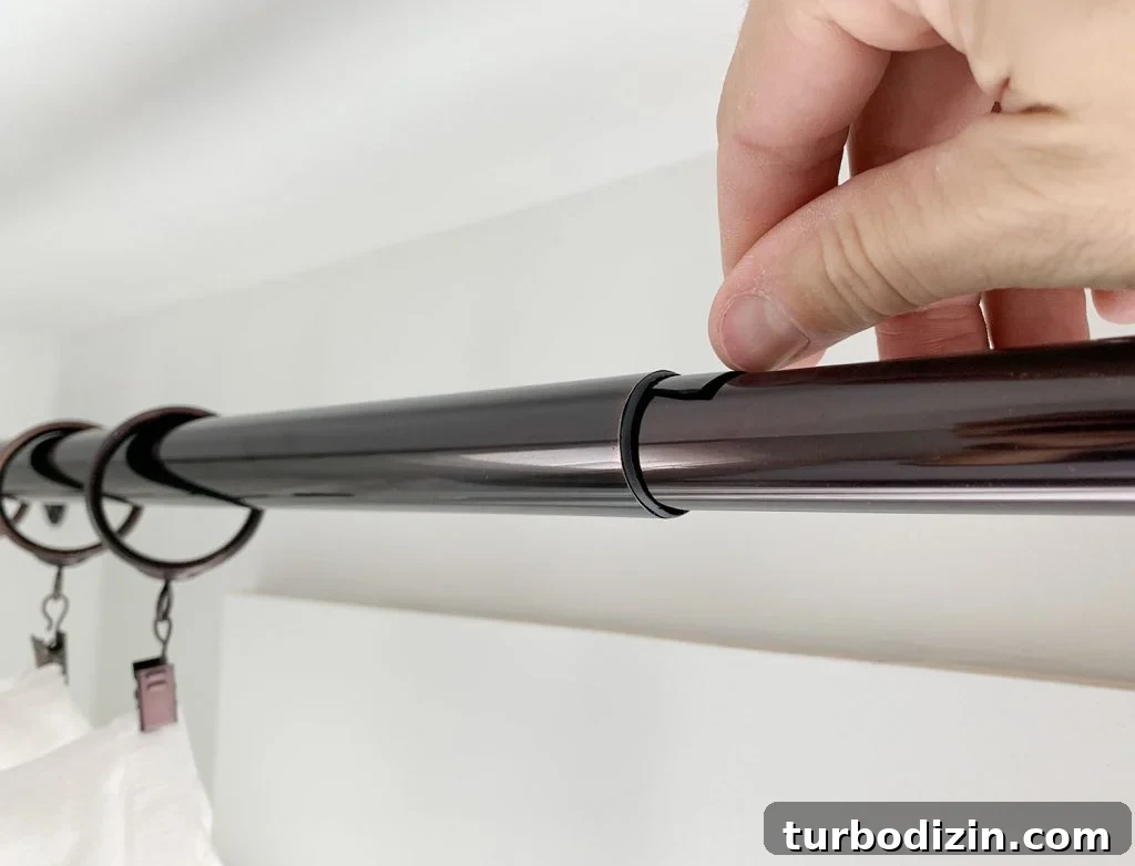 Put small plastic wedge in curtain rod to prevent sagging
