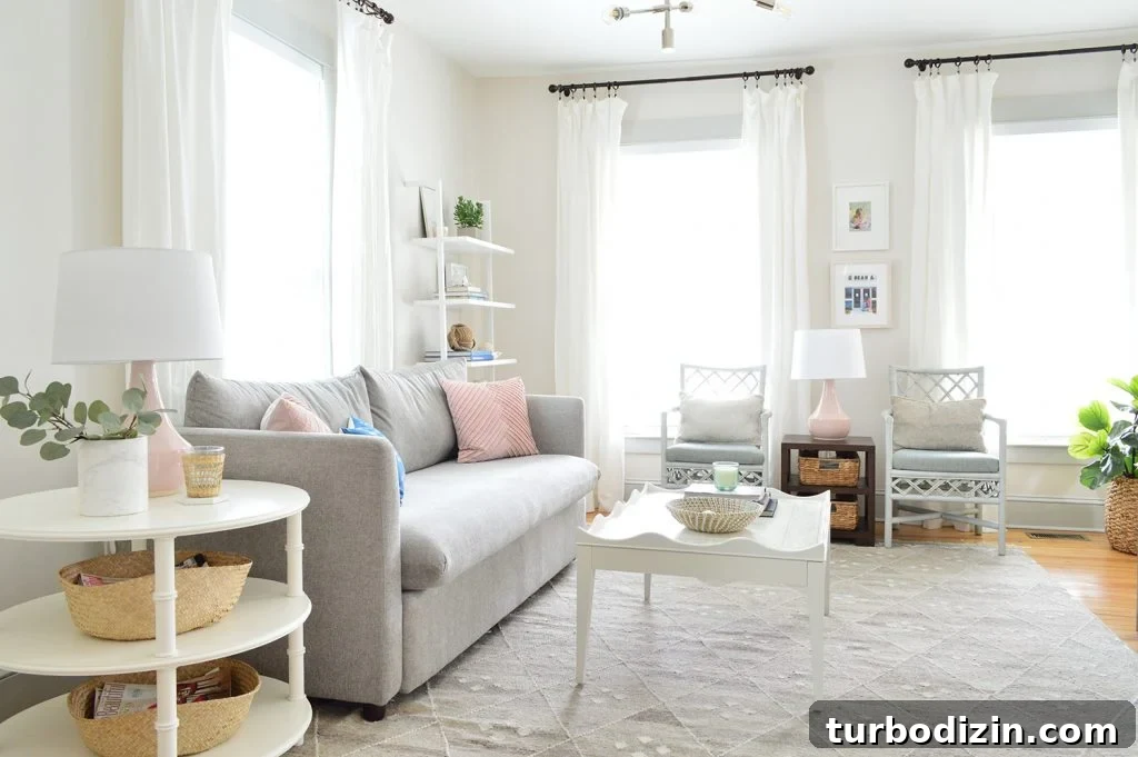 Beach house living room with tall white curtains on three windows