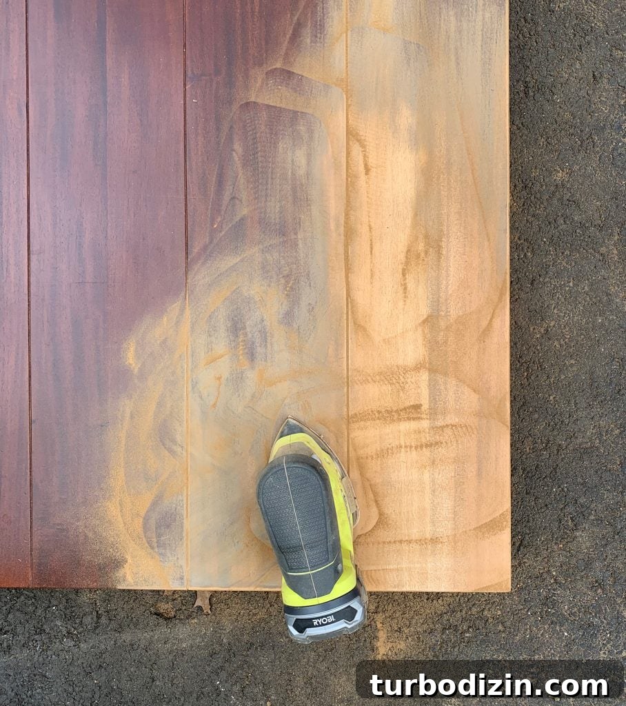 Refinish a Wooden Table: Step-by-Step Guide for Smooth Results 2 Sanding the finish off of a wood dining table to refinish it with new stain