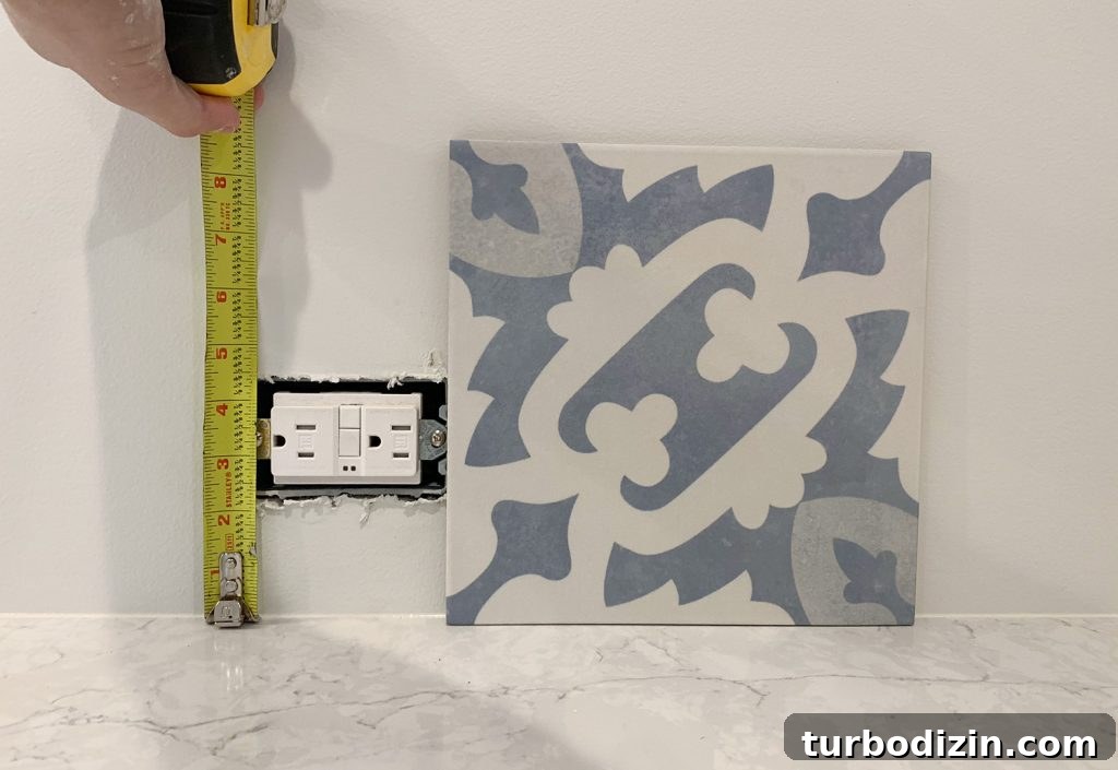 8 Essential Steps to Take Before You Start Tiling 10 Checking Backsplash Tile Against Electrical Outlet In Kitchen