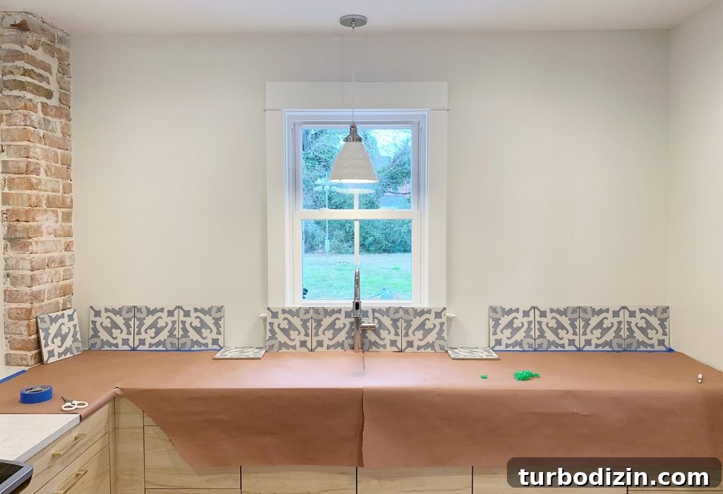 8 Essential Steps to Take Before You Start Tiling 11 First Row Of Backsplash Tile Laid Out Against Wall