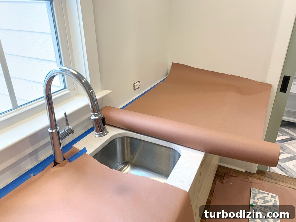 8 Essential Steps to Take Before You Start Tiling 14 Red Rosin Paper Protecting Kitchen Counter Before Backsplash Installation
