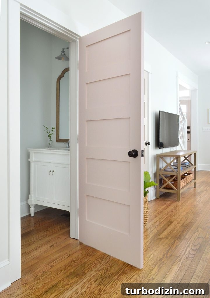 Duplex Living Room and Dining Room Makeovers: Before & After Tour 12 First Floor Powder Room With Pink Door