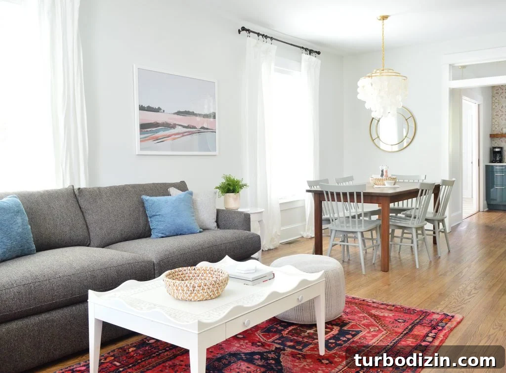 Duplex Living Room and Dining Room Makeovers: Before & After Tour 13 Open Living Dining And Kitchen With Crate And Barrel Sofa And Scallop Coffee Table