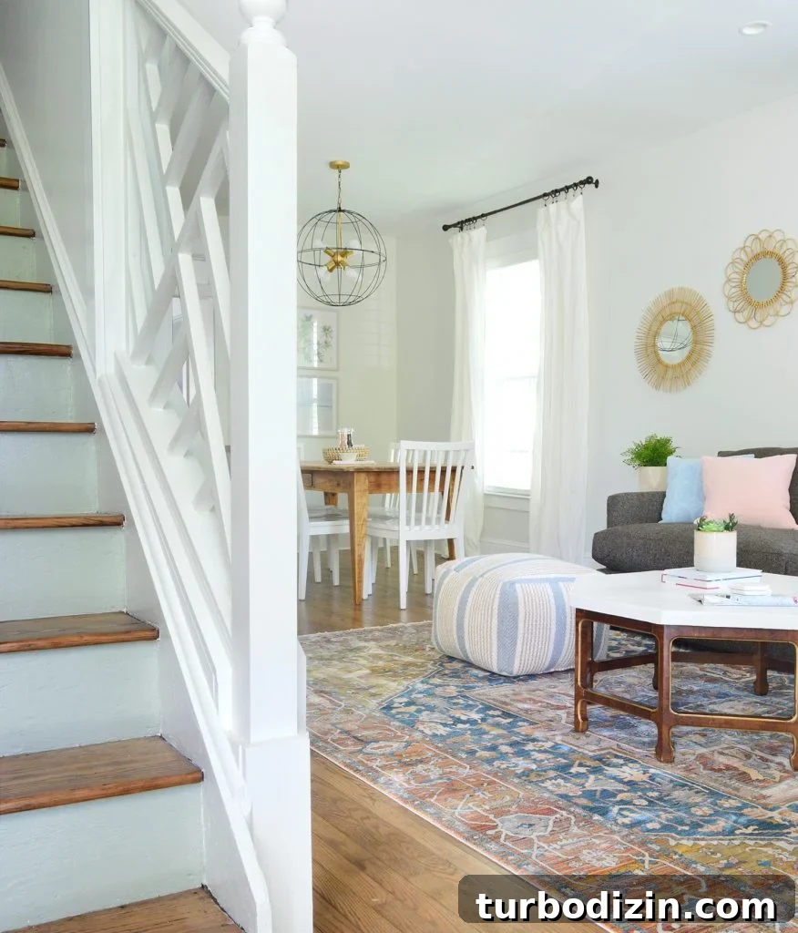 Duplex Living Room and Dining Room Makeovers: Before & After Tour 16 Chippendale Railing In Foreground Of Duplex With Blue Stair Risings
