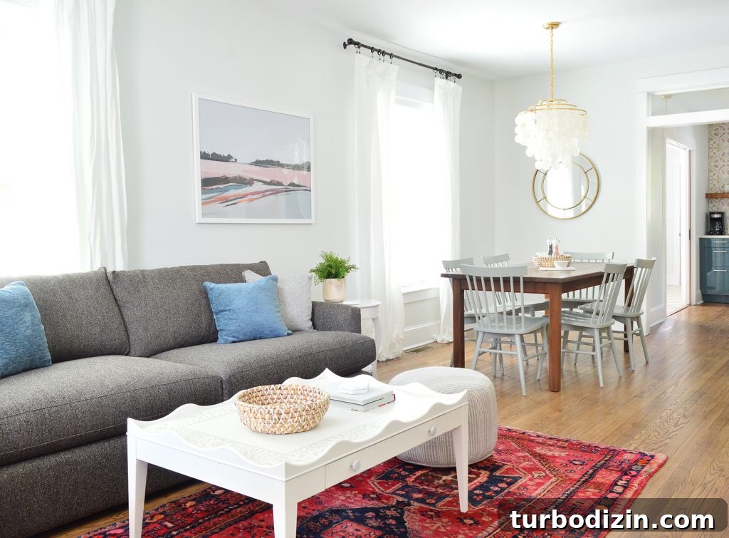 Duplex Living Room and Dining Room Makeovers: Before & After Tour 9 Open Living Dining And Kitchen With Crate And Barrel Sofa And Scallop Coffee Table