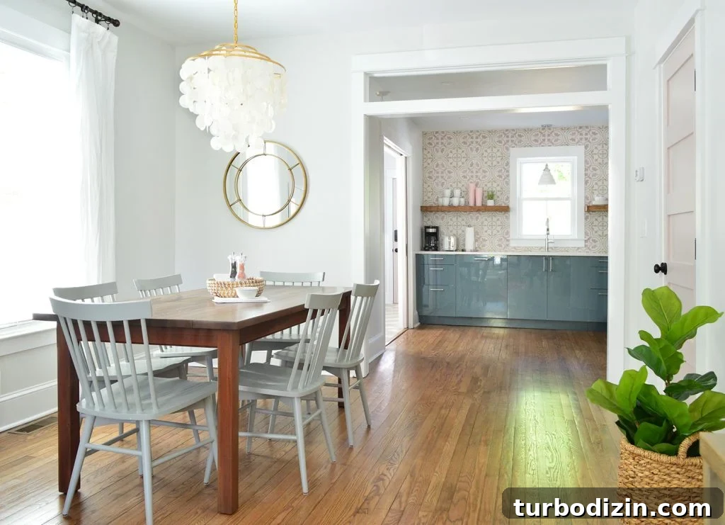 Bright Dining Room With Capiz Chandelier Looking Into Pink And Blue Kitchen