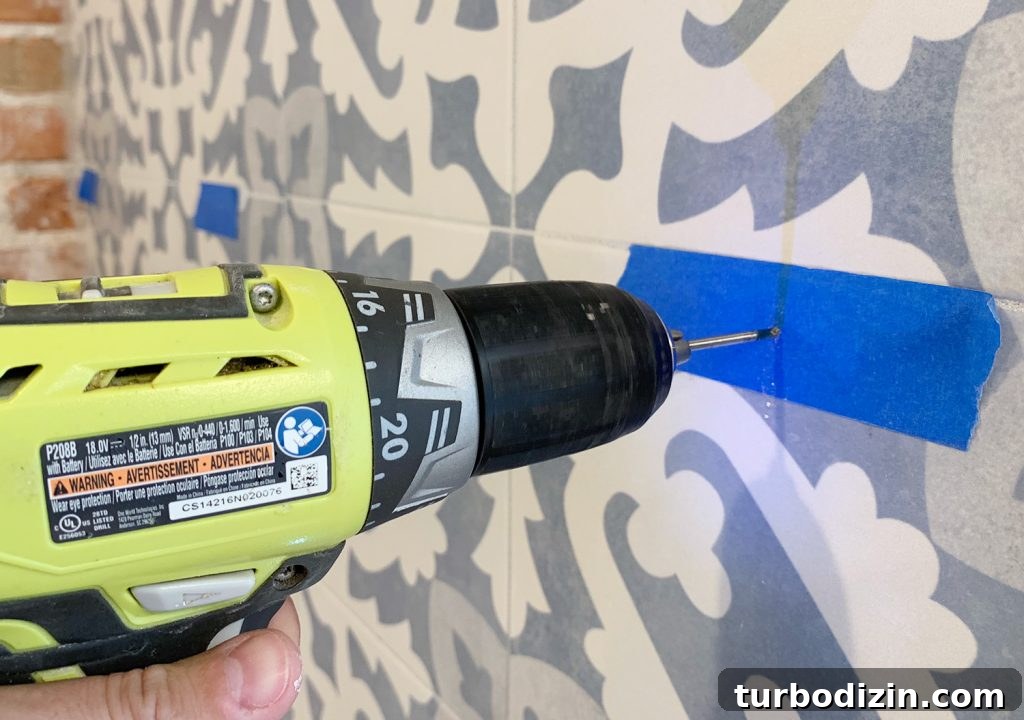 Drilling Through Tile Backsplash Using Marked Spot With Painters Tpae