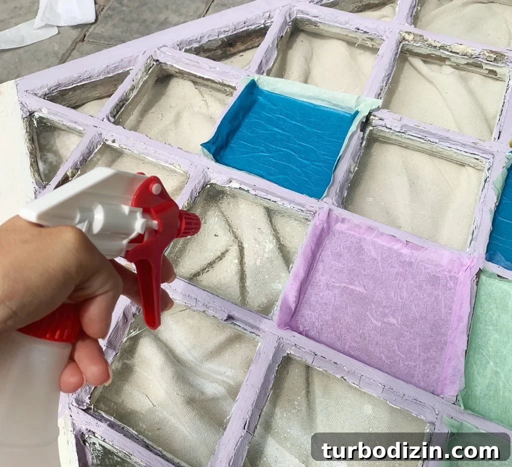 DIY Faux Stained Glass Window Tutorial: Step-by-Step Guide 10 Spraying Diamond Window Pane With Water From Spray Bottle