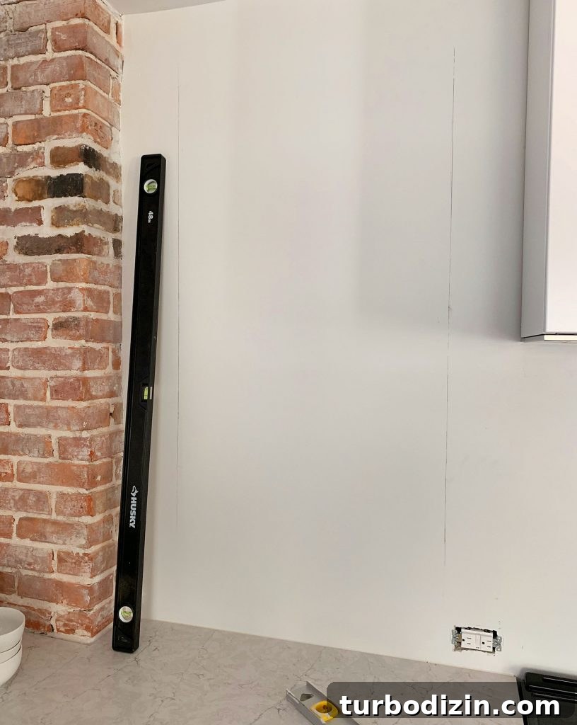 DIY Shiplap Wall Plank Makeover for $31 Total 12 Long Level Used To Mark Vertical Lines On Wall