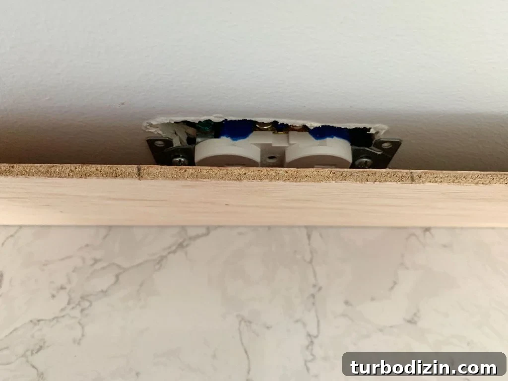 DIY Shiplap Wall Plank Makeover for $31 Total 14 Panel Marked In Front Of Electrical Outlet