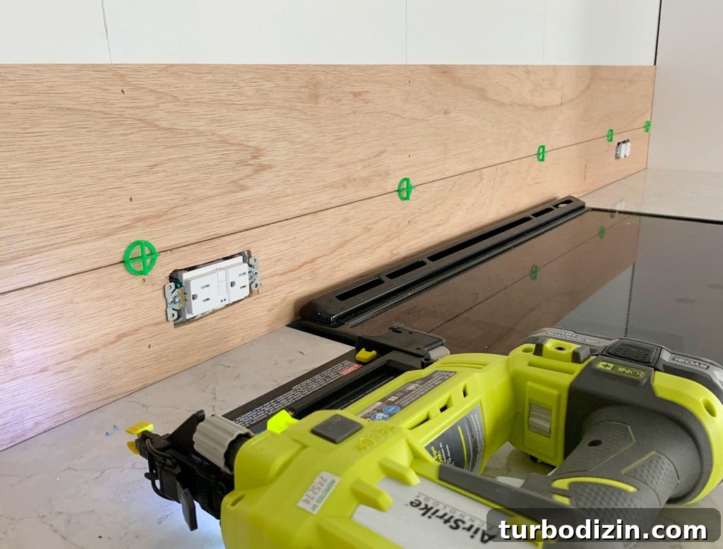 DIY Shiplap Wall Plank Makeover for $31 Total 18 First Two Panel Strips Installed Using Nail Gun and Green Tile Spacers