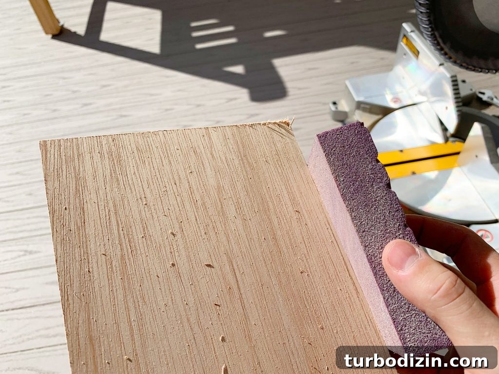 DIY Shiplap Wall Plank Makeover for $31 Total 9 Sanding Rough Edges Of Wood Panel Strip Using Sanding Block