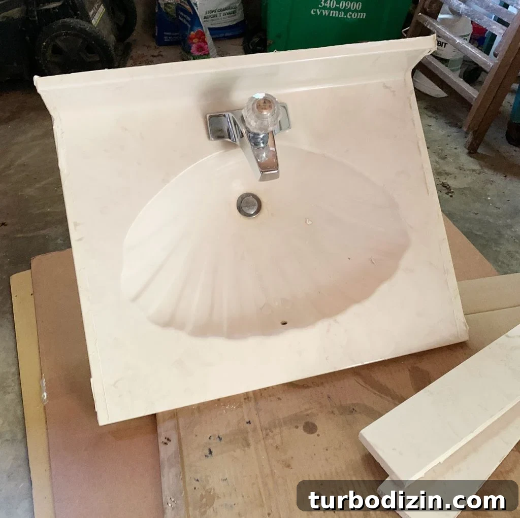 How to Plan a Bathroom Renovation: Step-by-Step Guide for Success 17 Seashell sink being removed